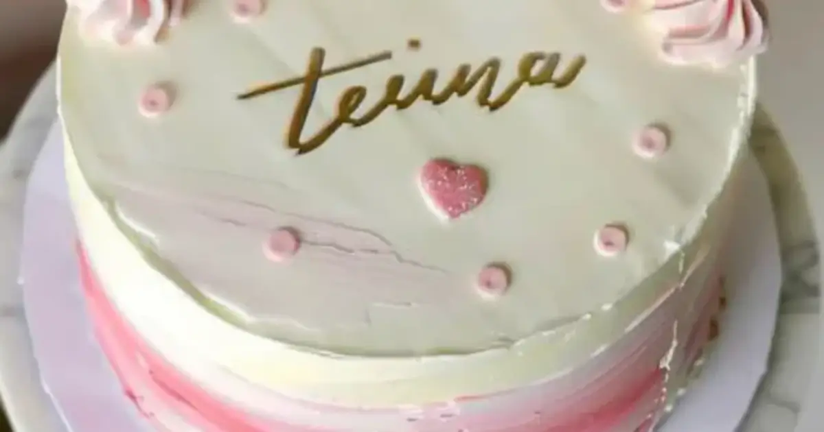 Simple minimalist birthday cake with pink roses, cream swirls, and subtle heart decorations.