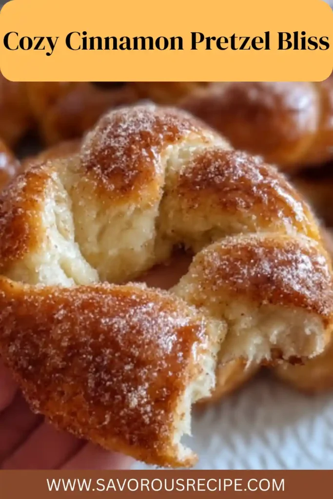 hand holding a warm cinnamon sugar pretzel with golden crust and sugar coating