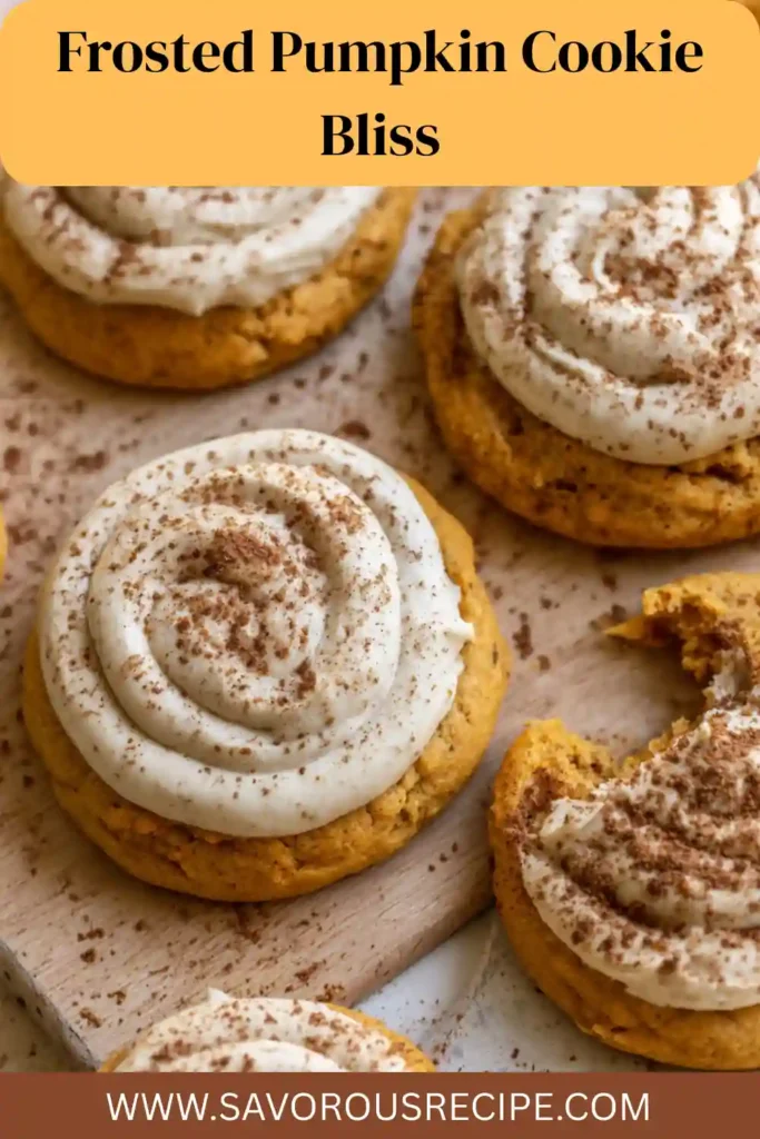 soft pumpkin cookies topped with swirls of creamy frosting and dusted with cinnamon on wooden board