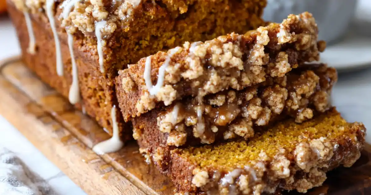 Close-up of sliced pumpkin streusel loaf with cinnamon crumble and glaze drizzle