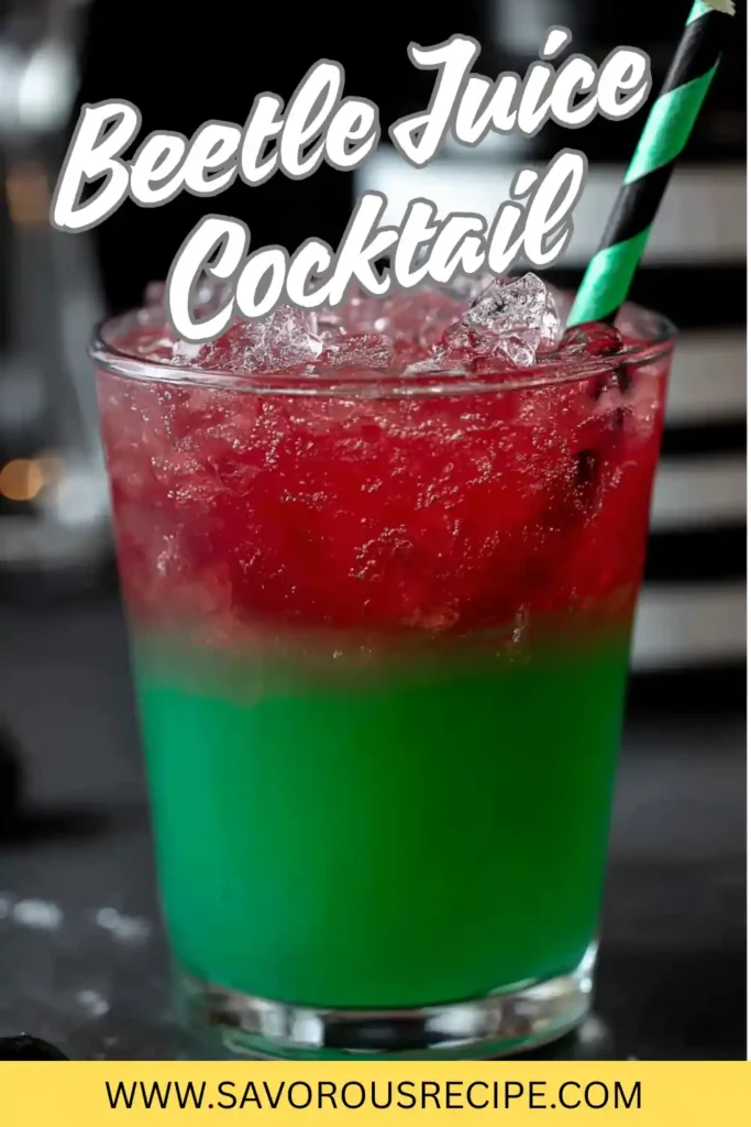 Beetle Juice cocktail with red and green layers over ice and a striped straw in a clear glass