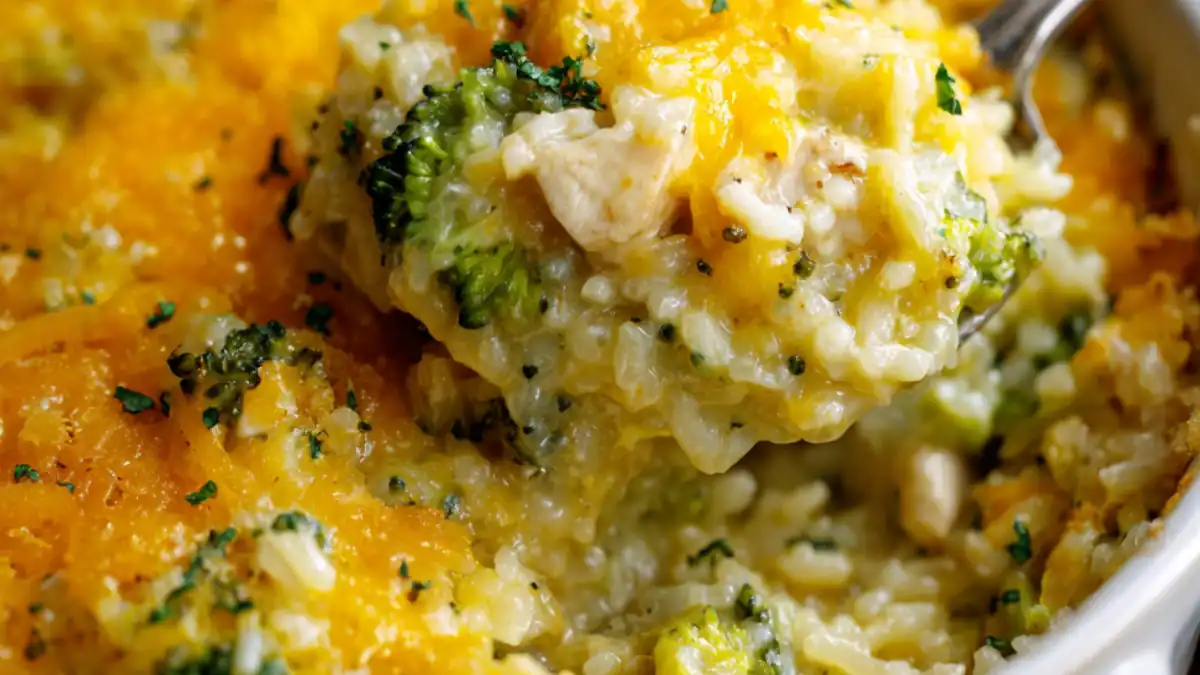 creamy broccoli chicken rice casserole with cheddar cheese topping