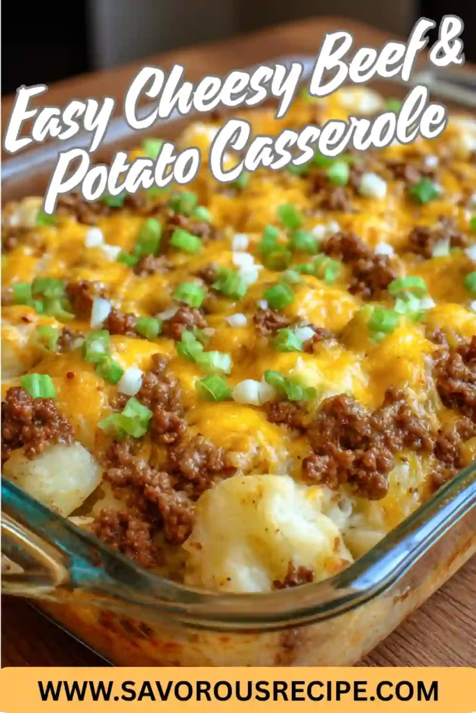 easy cheesy beef and potato casserole in a glass dish topped with cheddar, ground beef, and green onions