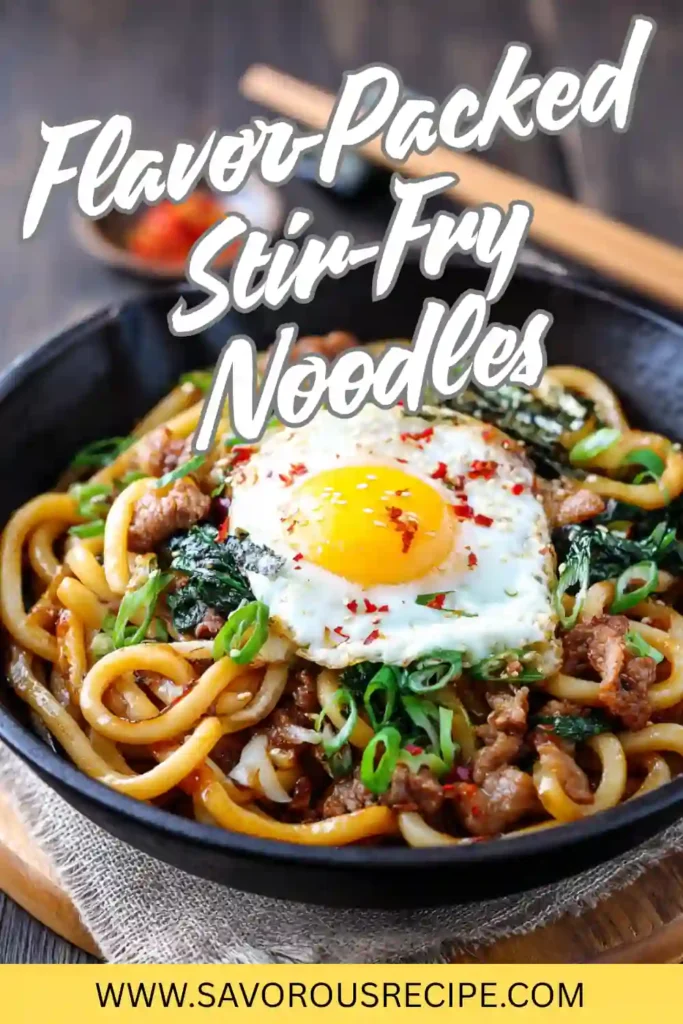 stir-fry noodles with beef, vegetables, scallions, and fried egg in a black bowl