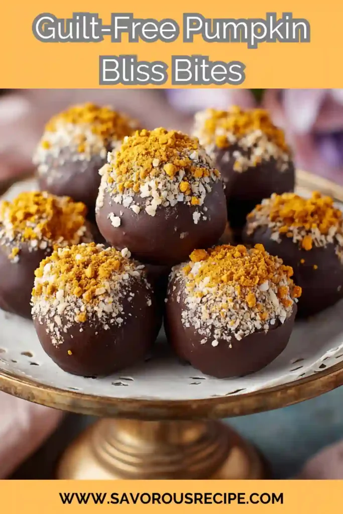chocolate-covered pumpkin bliss bites topped with crushed oats and spiced crumble on a cake stand