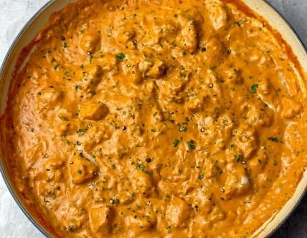 Delicious homemade butter chicken served with rice and naan bread