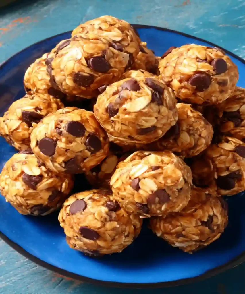 oat and chocolate chip protein energy balls stacked on a blue plate