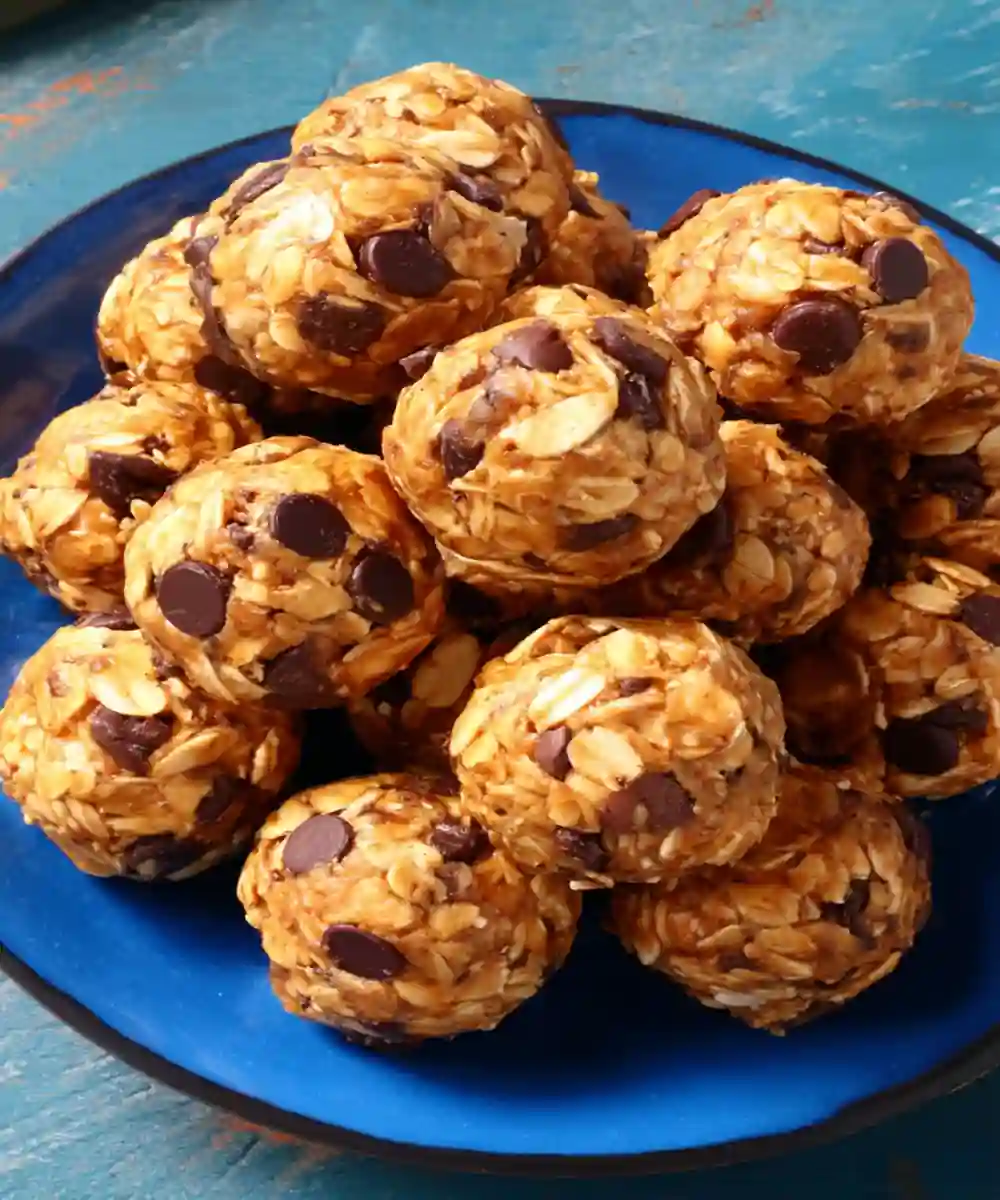 oat and chocolate chip protein energy balls stacked on a blue plate
