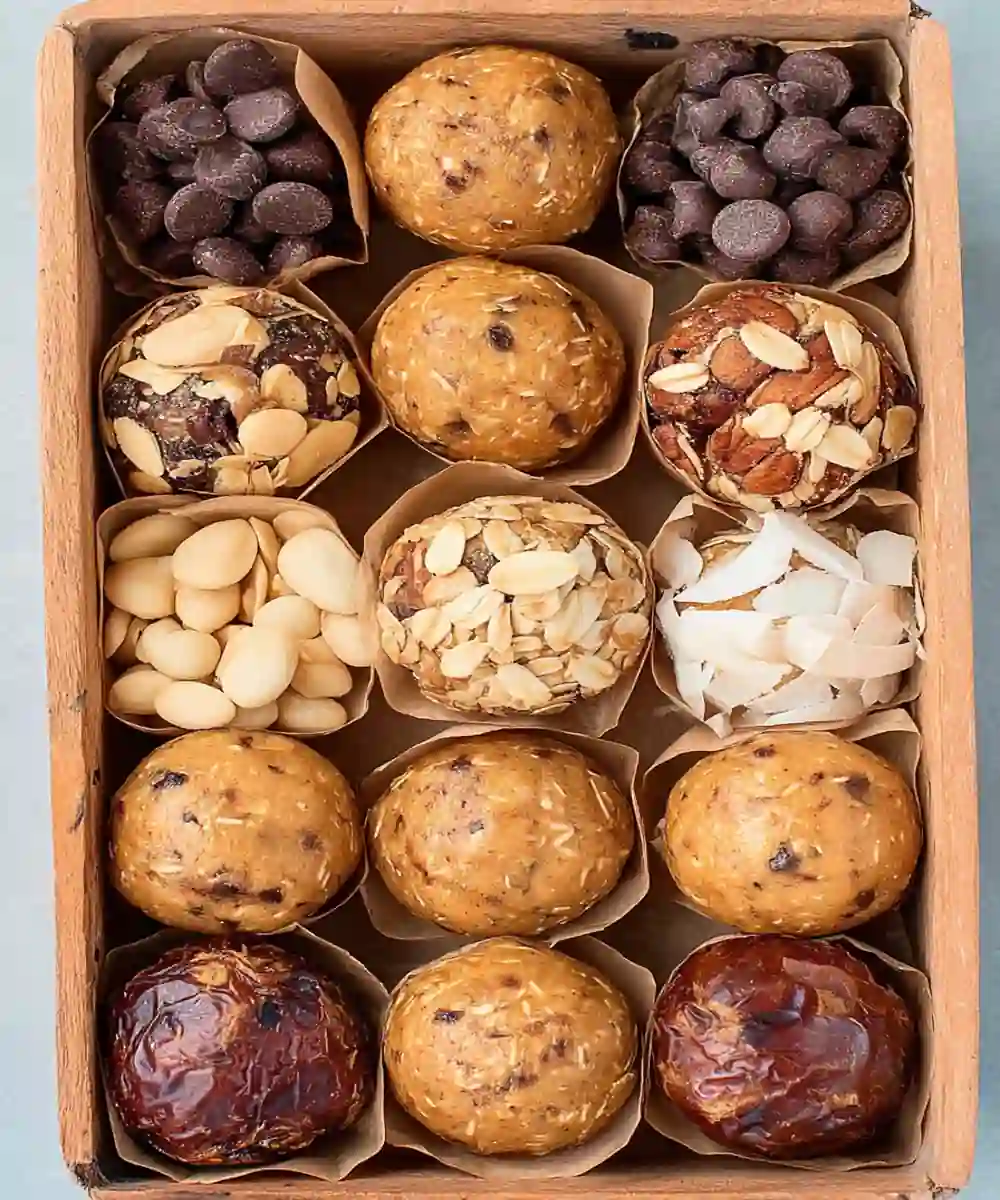 assorted protein energy balls with oats, chocolate, coconut, and nuts in a wooden box