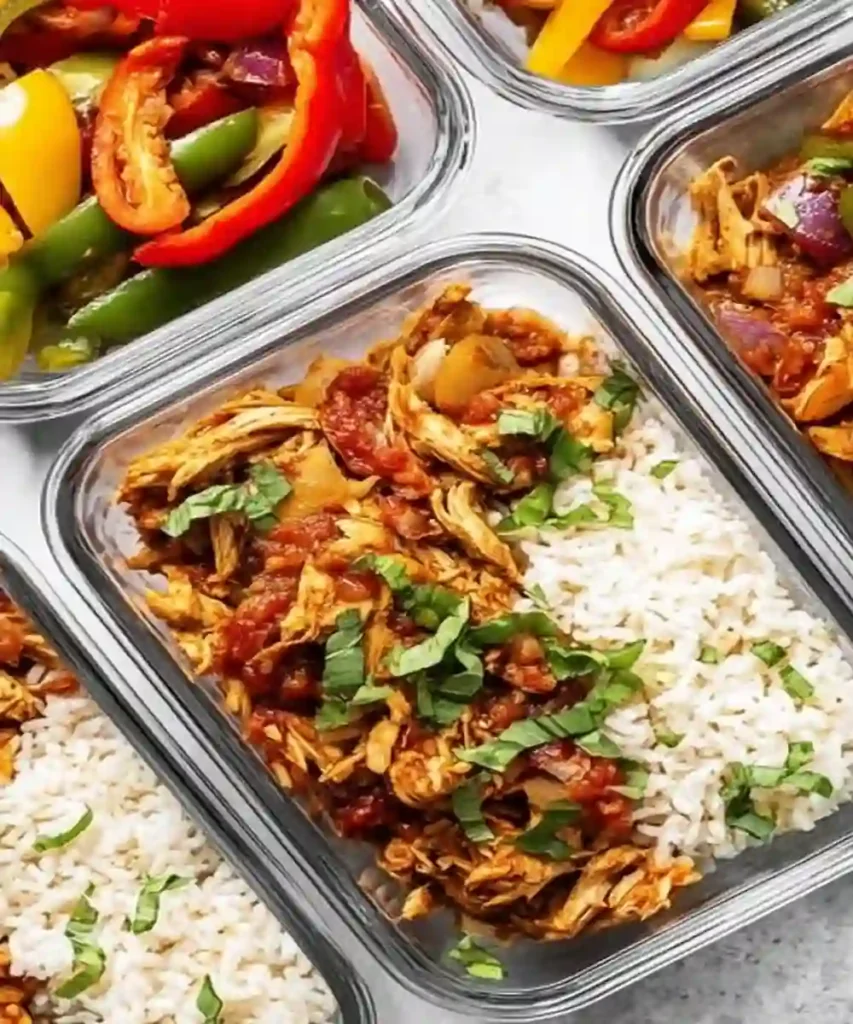meal prep containers with salsa chicken, rice, and sautéed bell peppers