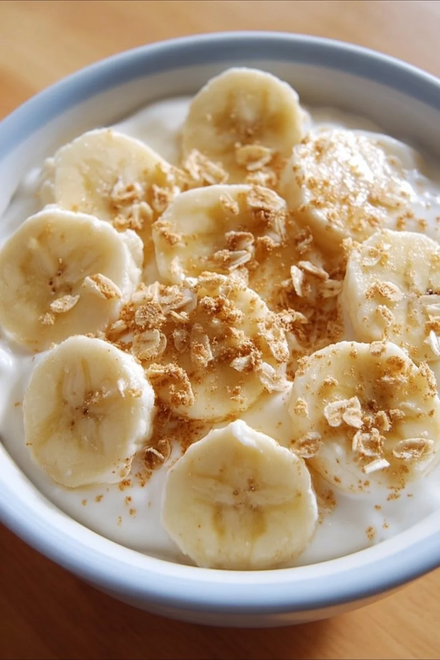 Delicious Banana Pudding Greek Yogurt Bowl topped with sliced bananas and whipped cream