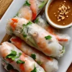 Assorted spring rolls with dipping sauces on a plate