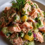 Delicious canned salmon salad served on a plate with fresh vegetables