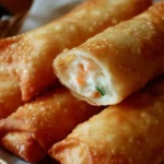 Crispy Crab Rangoon Egg Rolls served with dipping sauce