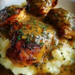 Delicious smothered chicken thighs in savory gravy served on a plate