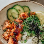 Delicious spicy salmon bowls with coconut rice topped with fresh vegetables