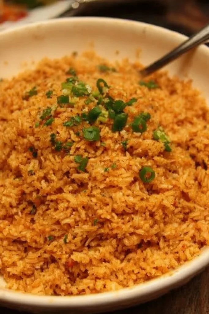Bowl of Texas Roadhouse seasoned rice garnished with herbs
