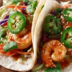 Delicious Thai-inspired shrimp tacos with vibrant toppings and fresh ingredients.