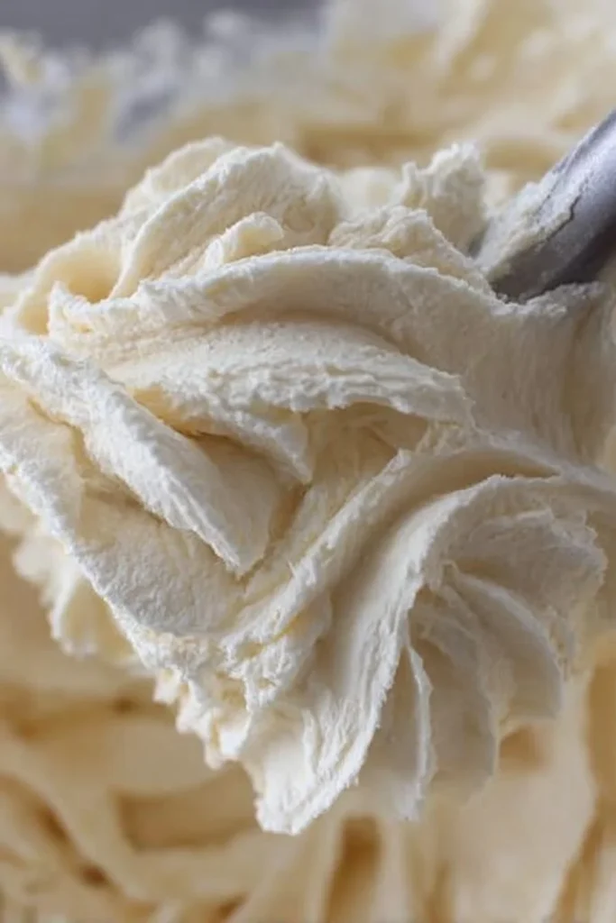Vanilla American Buttercream Frosting in a bowl with a spatula