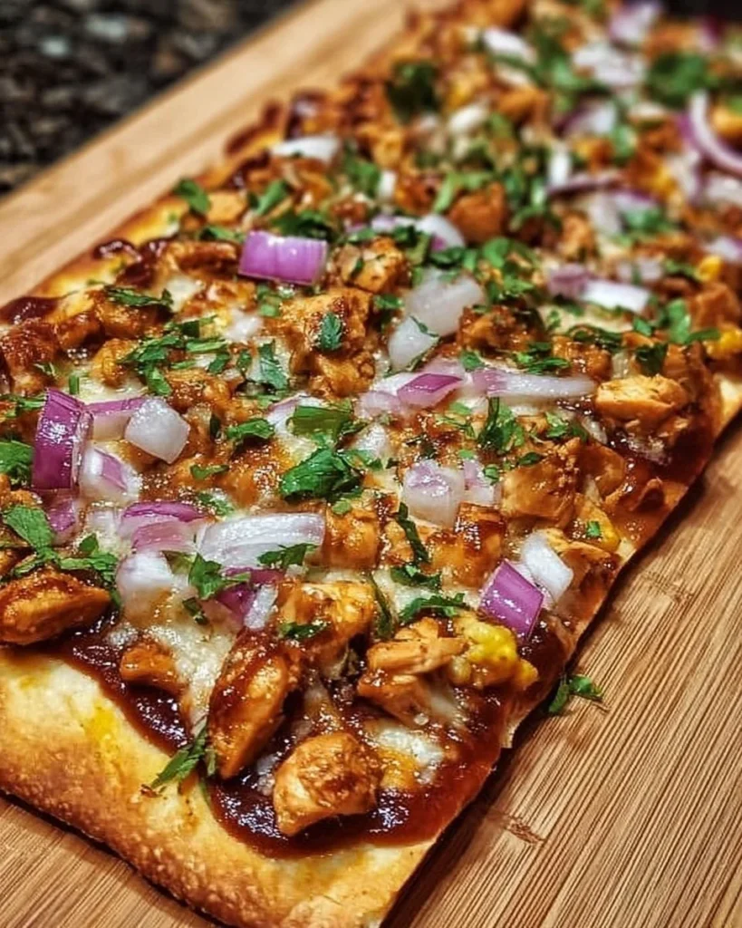 BBQ Chicken Flatbread Pizza topped with chicken, BBQ sauce, and cheese