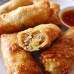 Crispy chicken egg rolls served with dipping sauce