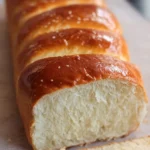 Freshly baked copycat Raising Cane's bread on a wooden table