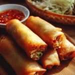 Delicious crispy chicken spring rolls served with dipping sauce.
