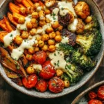 Colorful roasted veggie chickpea bowl with assorted vegetables and herbs