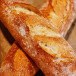 Freshly baked easy baguette on a wooden table