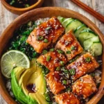 Honey glazed salmon bowl with fresh vegetables and rice for a healthy dinner