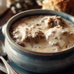 Delicious Pioneer Woman sausage gravy served over biscuits