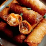 Delicious Southern-style crispy egg rolls served with dipping sauce.