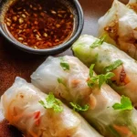Crispy air fryer rice paper noodle rolls filled with fresh vegetables and herbs.