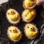 Bee-themed deviled eggs garnished with honey and edible flowers