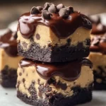 Delicious chocolate chip cookie dough brownie bites stacked in a tray.