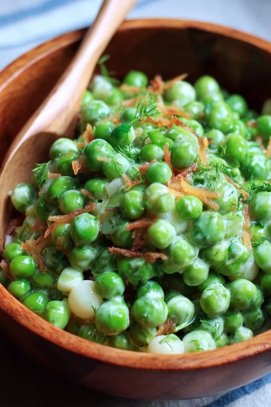 A vibrant cold green pea salad with fresh vegetables in a bowl.