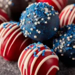 A plate of colorful Patriotic Oreo Balls decorated with red, white, and blue.