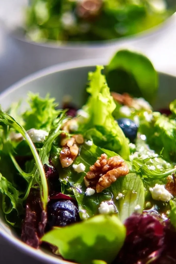 Colorful spring salad with fresh greens, veggies, and dressing