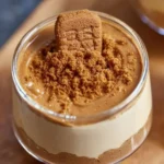 Delicious Biscoff mousse served in a glass with a cookie garnish.