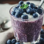 Delicious blueberry chia seed pudding topped with fresh blueberries and almonds.