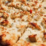 Delicious Chicken Alfredo Pizza topped with creamy sauce and grilled chicken