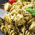 Creamy Chicken Pesto Pasta served in a bowl with fresh herbs and grated cheese.