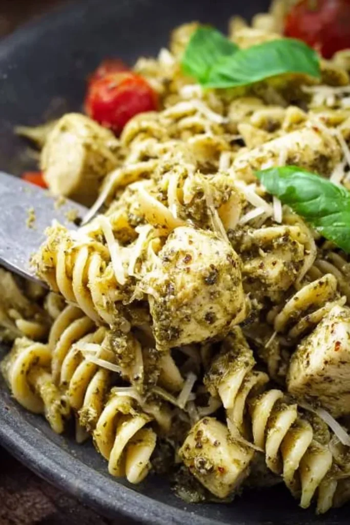 Creamy Chicken Pesto Pasta served in a bowl with fresh herbs and grated cheese.
