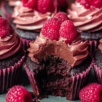 Delicious Chocolate Raspberry Cupcakes topped with fresh raspberries and chocolate frosting.
