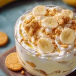 Classic Golden Oreo Banana Pudding served in a glass bowl, topped with banana slices.