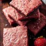 Delicious strawberry brownies topped with fresh strawberries and chocolate drizzle