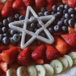 Colorful flag fruit tray with assorted fresh fruits for celebrations.