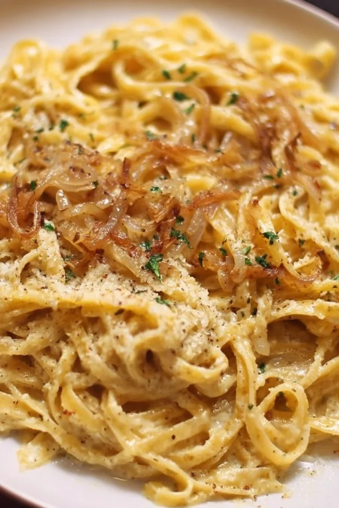 Delicious French Onion and Browned Butter Pasta dish garnished with herbs.