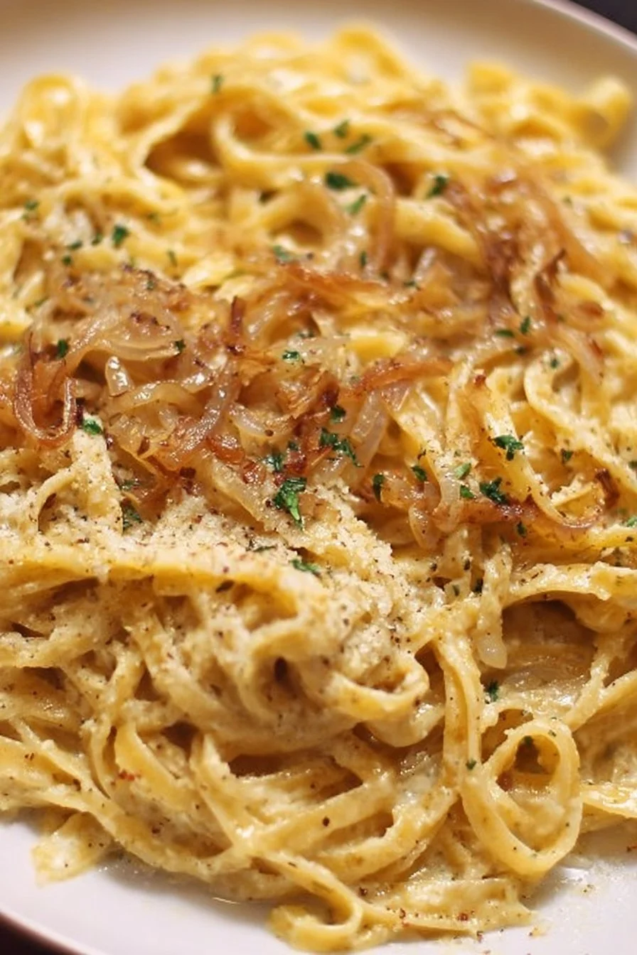 Delicious French Onion and Browned Butter Pasta dish garnished with herbs.
