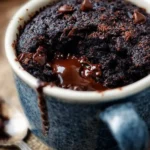 Delicious fudgy mug brownie in a ceramic mug, ideal for quick dessert cravings.